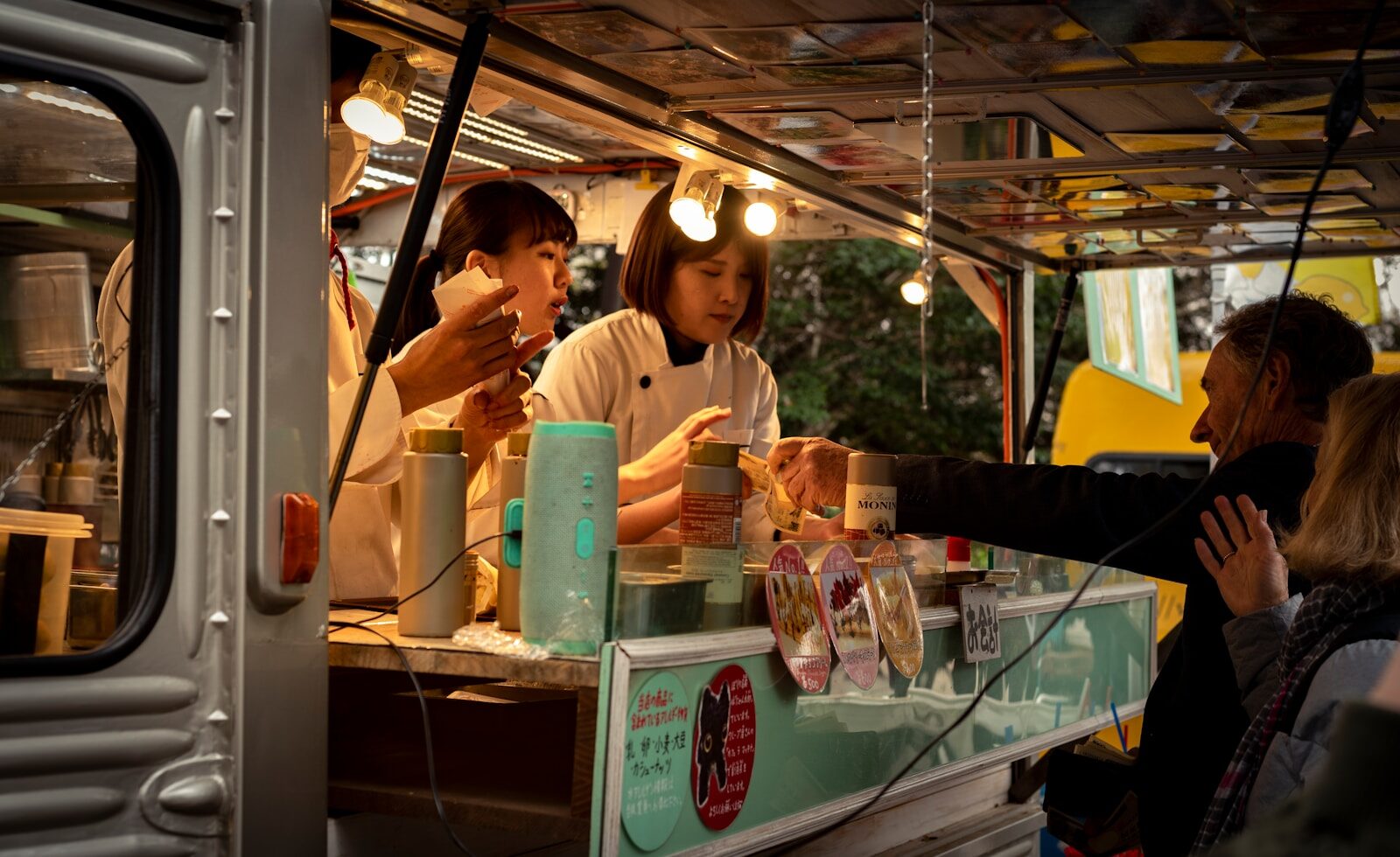 a group of people standing around a food truck